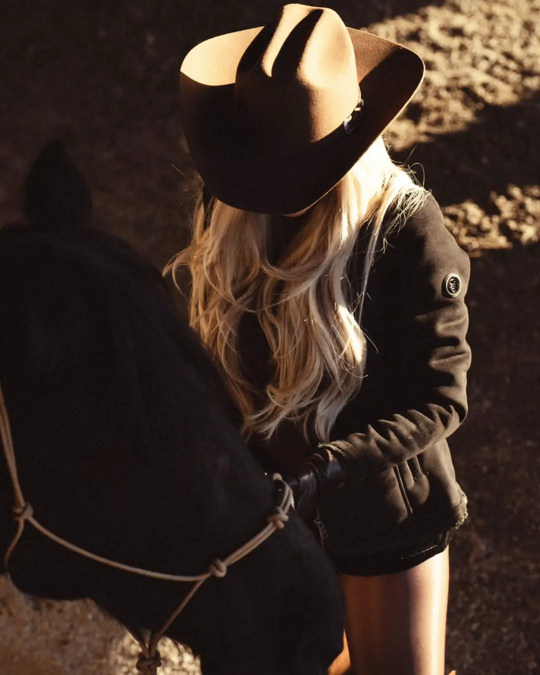 woman wearing tempco jacket standing next to a horse